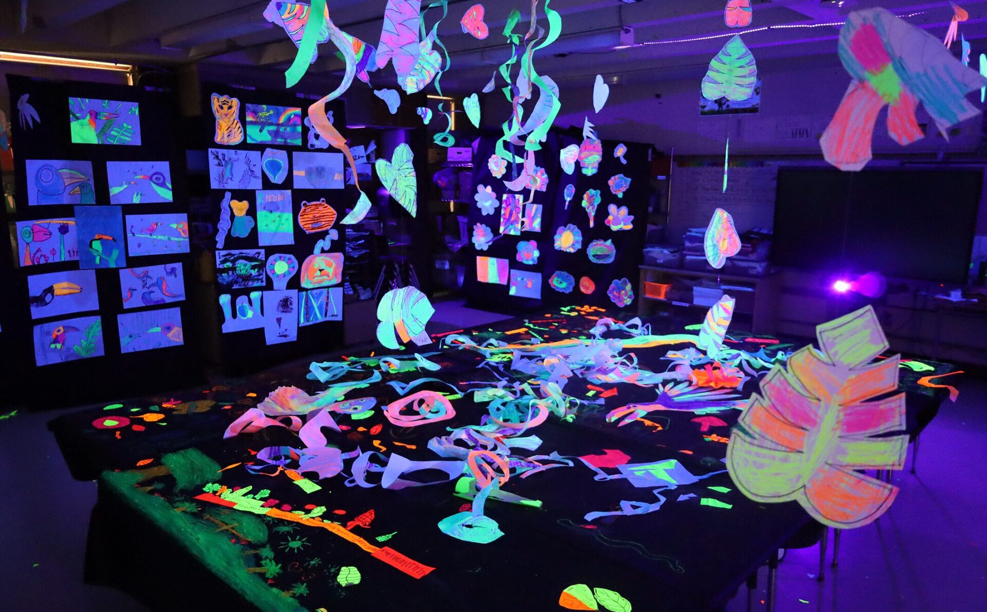 The art room at Harrington Elementary School was transformed into a glow-in-the-dark rainforest during the Celebration of the Arts event on Wednesday, May 22, 2026.