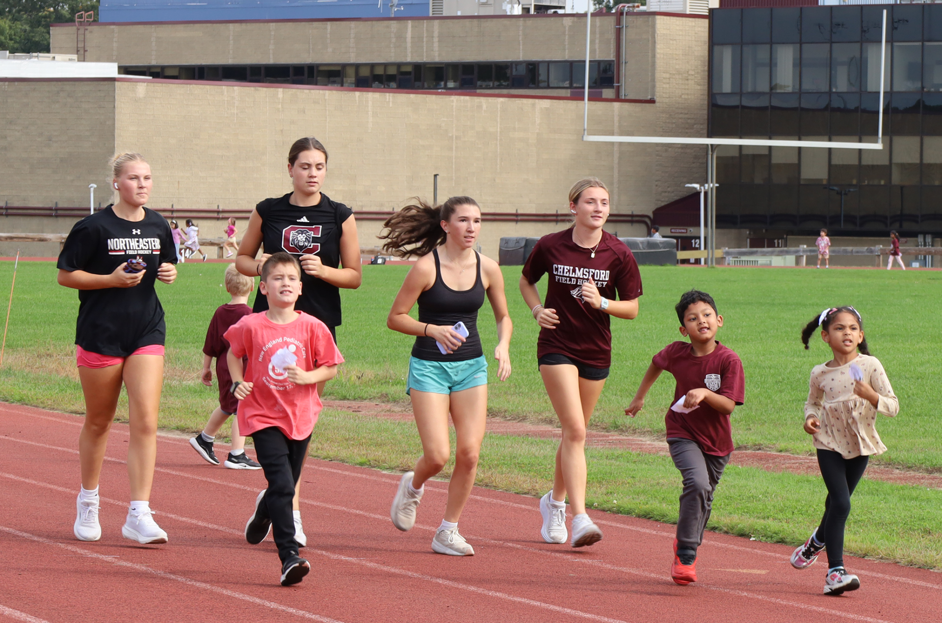 First grade students participate in the Harrington Elementary School Walk-A-Thon on Friday, October. 2, 2026, sharing the track with members of the CHS filed hockey team.