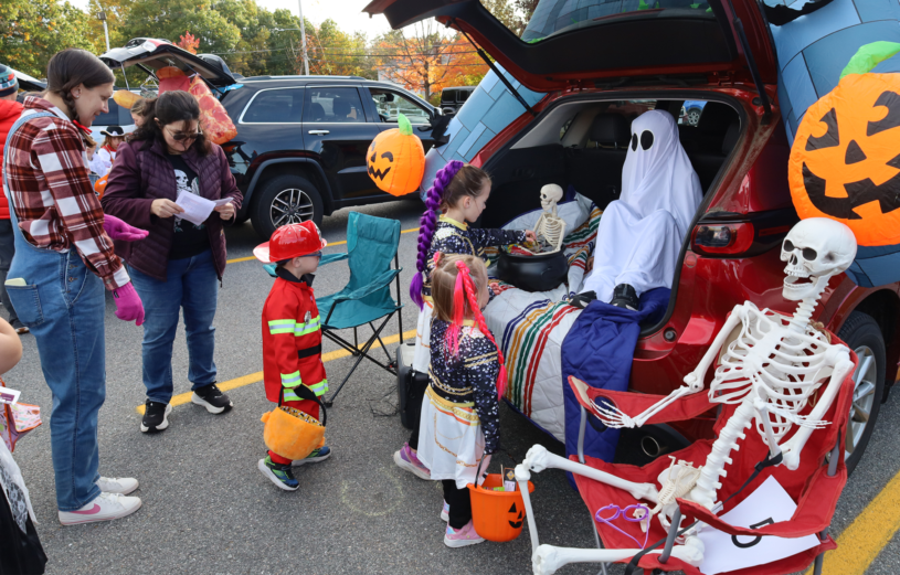 Harrington Elementary School students and their families enjoy trunk-or-treating in the parking lot on Saturday, October 17, 2026.
